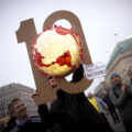 Demonstrators from the Fridays For Future movement with a symbol depicting the Earth burning, 10 years since the Paris Agreement, at a rally coinciding with COP30 in front of the Brandenburg Gate in Berlin, Germany