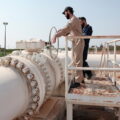 Workers operate the pipelines with natural gas, coming from Turkey and Azerbaijan, following the launch of natural gas exports to Syria, in Aleppo, Syria, August 2, 2025. REUTERS/Mahmoud Hassano