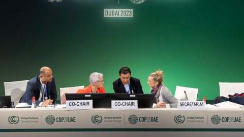 officials in discussion at Cop28 climate talks in Dubai