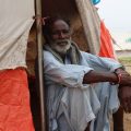 Man in tent after floods in Pakistan