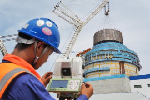 A staff member monitors the hoisting process of the CB20 module at the nuclear island hoisting site of Unit 3 of Shandong Haiyang Nuclear Power Plant in Yantai, Shandong, China