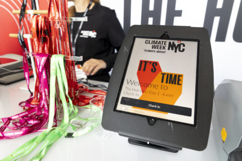 The check-in desk on Day 2 of Climate Week NYC 2024 at The Glasshouse, New York City