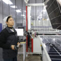 A worker manufactures solar photovoltaic modules at the workshop of Alternative Energy (AE) Solar Co, Ltd in Huaian, Jiangsu Province, China.
