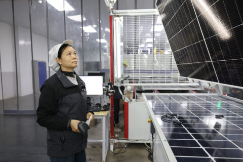 A worker manufactures solar photovoltaic modules at the workshop of Alternative Energy (AE) Solar Co, Ltd in Huaian, Jiangsu Province, China.