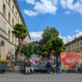 People sit and rest near the climate garden installation ''Keep Green - Der Klimawandel-Garten'' during the Zamanand Festival outside the university buildings on Ludwigstrasse in Munich, Bavaria, Upper Bavaria, Germany