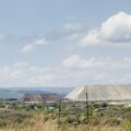A large pile of platinum mining waste surges above the horizon in South Africa