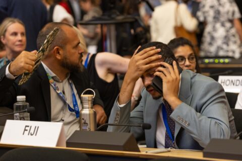 Delegates react to the suspension of the closing plenary on Thursday night at UN plastics talks in Geneva