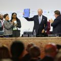 COP21 president Laurent Fabius holds up the text of the Paris Agreement.